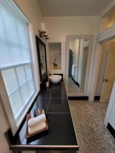 a large bathroom with a toilet and a sink at Luxury Historic North Hills Home in Knoxville +54 photos