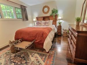 a bedroom with a large bed and a dresser at RoyalBear - AC, Hot Tub, Grill, FirePit, Gameroom in Killington