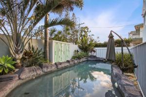 a swimming pool in a yard with a fence at Esplanade 180, Golden Beach in Golden Beach