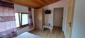 a bedroom with a bed and a window and a chair at Holiday House Krapets in Krapets