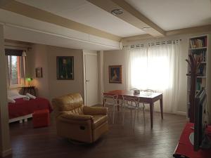 a living room with a table and a chair and a bedroom at open in Potenza +34 photos