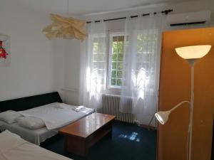 a room with a bed and a table and a window at RiverRetreat in Belgrade +10 photos