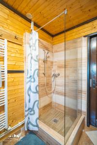 a bathroom with a shower in a wooden wall at Rum Haz in Borzont +92 photos