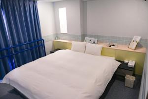 Postel nebo postele na pokoji v ubytování Hotel HERB ホテルハーブ大人用