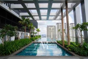 a swimming pool in the middle of a building at Pavilion Bukit jalil Walking Distance 2 Bedroom 2-4Pax in Kuala Lumpur
