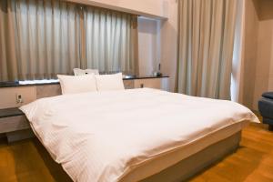 Postel nebo postele na pokoji v ubytování Hotel HERB ホテルハーブ大人用