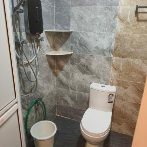 a bathroom with a toilet and a shower at Bang Brahim Roomstay in Parit Raja +12 photos