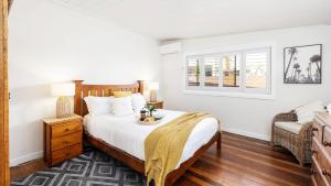 a bedroom with a large bed and a window at Beach Bungalow in Corlette