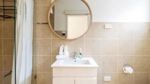 a bathroom with a sink and a mirror at Beach Bungalow in Corlette