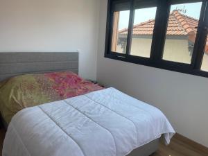 a bed in a bedroom with a window at F3 à mimizan plage in Mimizan-Plage