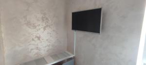 a television hanging on a wall in a room at Menrat in Novi Sad +8 photos
