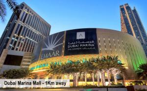 a large building in a city with tall buildings at Luxury Escapes - Studio in JLT X1 Tower close to Metro in Dubai