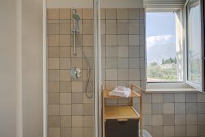 a bathroom with a shower and a window at Casa al Cor Apartments in Nago-Torbole +76 photos