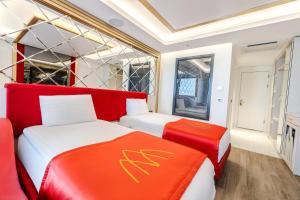two beds in a room with red and white at Granada Luxury Red Adult Only in Alanya