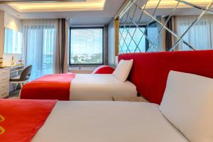 two beds in a room with red and white at Granada Luxury Red Adult Only in Alanya