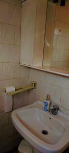 a bathroom with a white sink and a mirror at ORFANIDISHAUS 300 m απο παραλια ΟΡΦΑΝΙΟΥ - in Orfánion