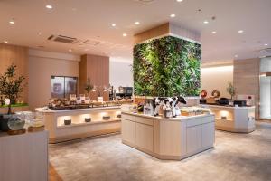a large aquarium in the middle of a store at HOTEL MYSTAYS Kumamoto Riverside in Kumamoto