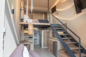 a staircase leading up to a room with a bunk bed at Helios - Luxury by the Sea in Paralia Katerinis +26 photos