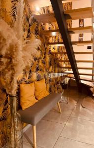 a room with a bench with yellow pillows on a wall at Chambre bleu in Orgères