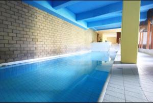 a swimming pool in a building with a blue ceiling at St Moritz Suite in St. Moritz