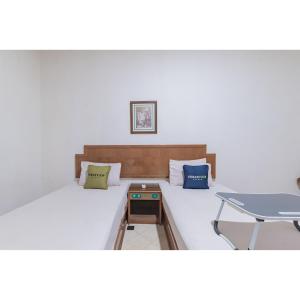 Letto o letti in una camera di Urbanview Hotel Utari
