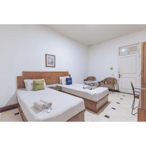 Postel nebo postele na pokoji v ubytování Urbanview Hotel Utari + 21 fotografií