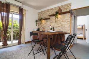 a kitchen with a wooden table and chairs at Schilirò House in Piedimonte Etneo +13 photos
