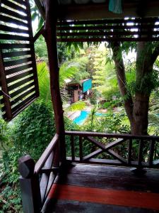 a view of a garden from the porch of a house at Comon Bungalow HaadChaoPhao in Haad Chao Phao