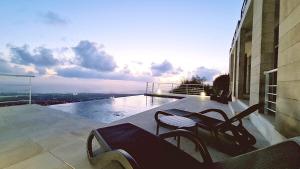 a balcony with a table and chairs on a building at STAY Sunset Palazzo in Tala