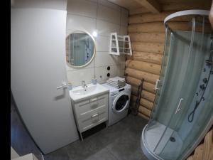 a bathroom with a washing machine and a sink at Kwietna łąka na szlaku in Jarnołtówek +32 photos