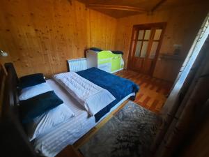 a bedroom with a large bed in a wooden room at Карпатський двір in Krivorovnya