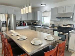 a kitchen with a table with cups and saucers on it at 轻松客栈 in Fairbanks
