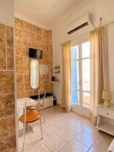 a room with a table and a chair and a window at ERRIKA in Ermoupoli +70 photos