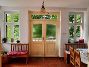 a room with a door with windows and a table at Dom na Mazurach Pilec in Pilec