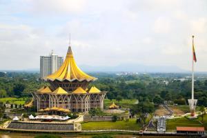 a pagoda with a yellow roof in a city at Merdeka Palace Hotel & Suites in Kuching