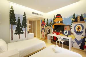 a bedroom with a christmas mural on the wall at Beat Hotel Bangkok in Bangkok