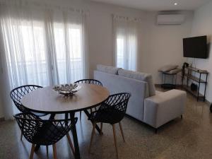 a living room with a couch and a table and chairs at Apartament IXA-2 in Manresa