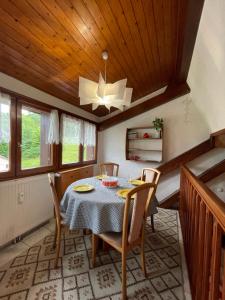 a dining room with a table and chairs at Rare 2 bedroom with private beach on Lake Annecy in Doussard