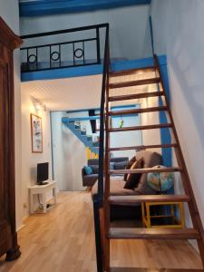 a room with a bunk bed and a staircase at La Maison-frite, pour un séjour insolite à Foix ! in Foix