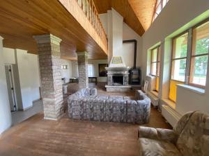 a living room with a couch and a fireplace at Maja Nurme 47, Narva-Jõesuu in Narva-Jõesuu +9 photos