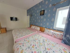 Postel nebo postele na pokoji v ubytování MrLee Dalat House