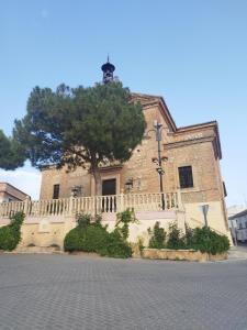 a large stone building with a tree in front of it at Casa Real in Salar