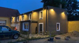 a house with a car parked in front of it at Pension Flughafen Leipzig in Freiroda