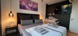a bedroom with a large bed with towels on it at MEERBLICK DUPLEX POOL-VILLA REGIRMA DELUXE bis 8 Personen in Vodice +69 photos