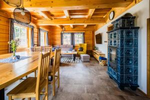 a dining room and living room with a table and chairs at Wellness Roubenka Goldenstein in Branná