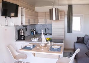 a kitchen with a table with a sailboat on it at Mobilehome Palema 16 in Drage +18 photos