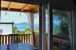 a view of the ocean from the porch of a house at Mobilehome Palema 16 in Drage