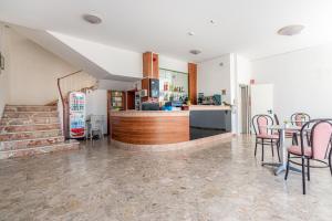 a kitchen and dining room with a table and chairs at Hotel Serafini in Rimini