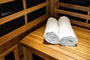 a stack of white towels sitting on a wooden bench at Hotel Arima & Spa - Small Luxury Hotels in Donostia-San Sebastián