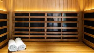 a sauna with white towels in a wooden room at Hotel Arima & Spa - Small Luxury Hotels in Donostia-San Sebastián